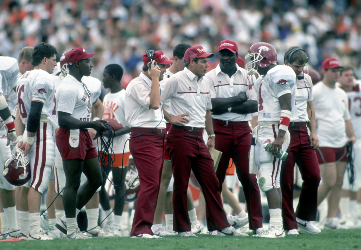 Arkansas Razorbacks head coach Ken Hatfield talks to quarterback (4) Quinn Grovey on the sidelines against the Miami Hurricanes at the Orange Bowl. 